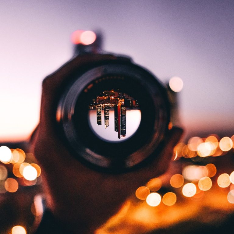 view of a city through lenses at sunset